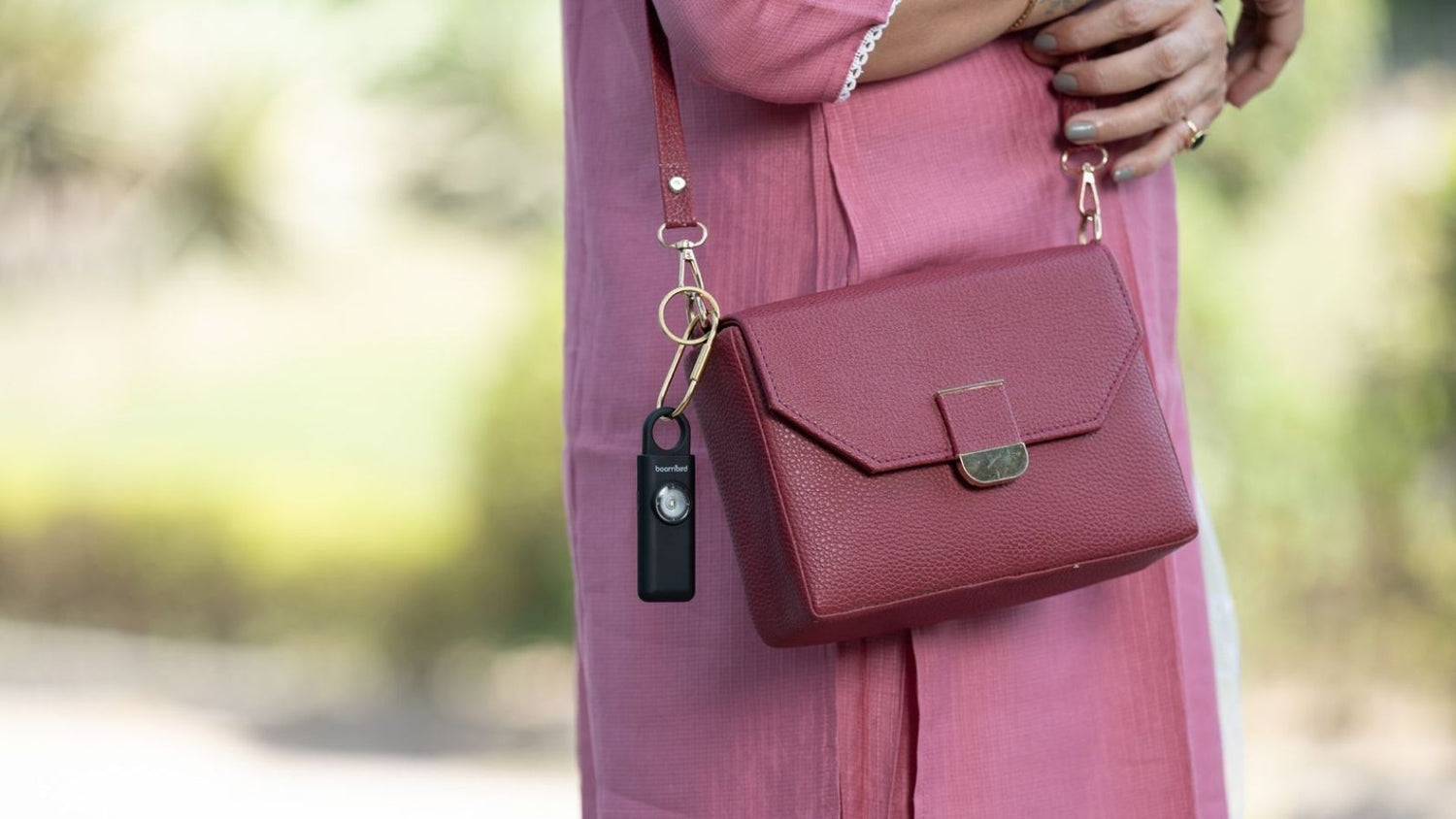 Women commuting to work with Personal safety alarm device attached to bag